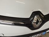 the front end of a white car with a black grille