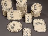 a group of blue and white plates and bowls on a table