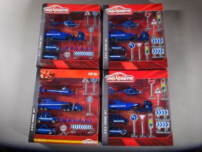 four toy vehicles in the package on the table