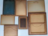 many different types of old wooden boxes on the wall