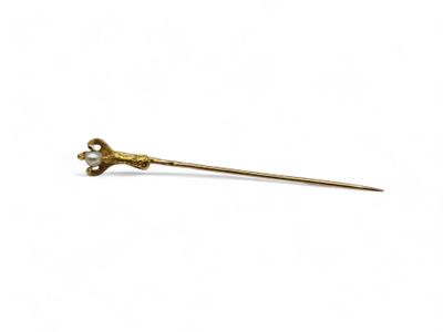 an image of a gold stick with a flower on top of it