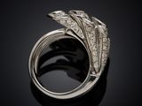 a close up of a diamond ring on a black surface