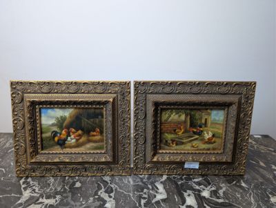 two framed paintings of chickens and chickens on a table
