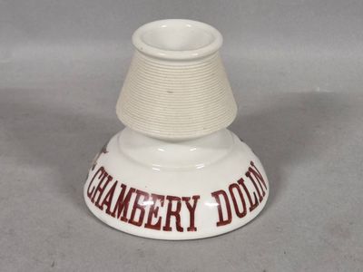 a white vase that has a red and white design on it