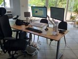 a desk with two monitors and a laptop on it