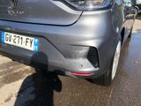 the rear end of a silver car parked in a parking lot