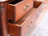 a wooden dresser with two drawers and a mirror