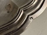 a close up of a silver plate on a table