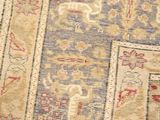close up of an antique persian rug with various colors and patterns