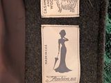 a label on the back of a jacket that has a picture of a woman in a dress