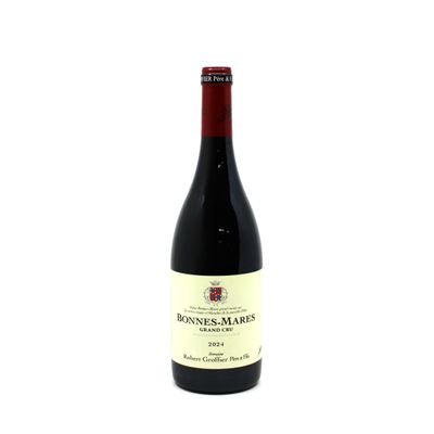 a bottle of wine sitting on top of a white table