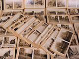 many old black and white pictures on the table