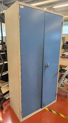 a blue cabinet in the middle of a room