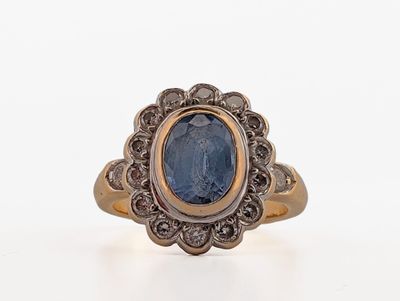 a close up of a ring with a blue stone in it