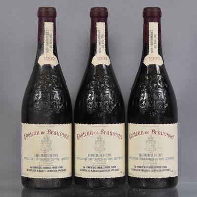 three bottles of wine are lined up on a table