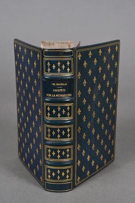 an old book with a blue cover and gold trim