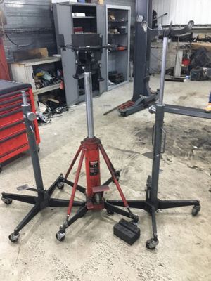 two jack stands in a garage with tools on them