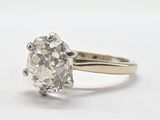 une image d'une bague en diamant sur une surface blanche