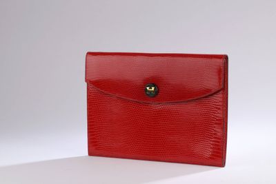 a red lizard skin wallet with a gold clasp