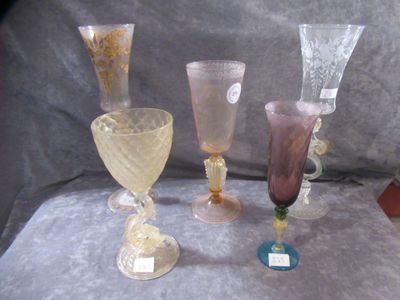 three different colored glass vases sitting on a table