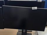 a desk with two monitors and a keyboard on it