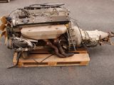 a small engine sitting on a pallet in a parking lot