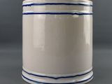a close up of a white container with blue stripes