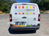 a white van that has a colorful sticker on the back of it