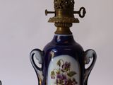 a lamp that has a blue and white vase on it