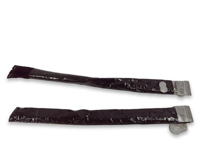 two pieces of black plastic with a metal clasp on them