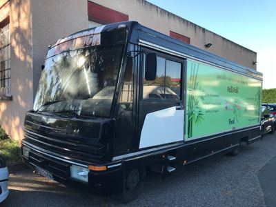 un bus noir et blanc garé devant un immeuble