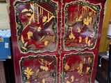a red cabinet with gold and black designs on it