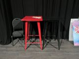 two red stools sitting next to each other on a stage