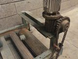 a machine that is sitting on the ground next to a brick wall