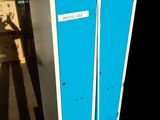 two blue lockers sitting on a pallet in a warehouse