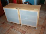 a small cabinet with two doors on the floor