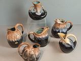 five different types of vases sitting on a table