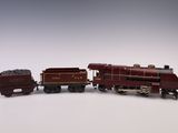 deux petits trains miniatures posés sur une surface blanche