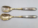 two spoons that are sitting next to each other on a table