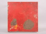 an old book with a red cover sitting on a table next to a pencil