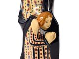 figurine d'une femme tenant un enfant dans ses bras
