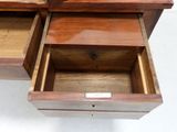 a wooden desk with two drawers on top of it