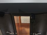 a black cabinet with a mirror on it in a room
