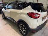 the rear end of a white car parked in a garage