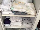 a small cabinet with a lot of clothes in it