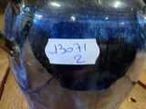 a blue vase with a tag on it sitting on a table