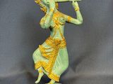an image of a statue of a woman playing a flute