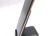 a cell phone that is on a stand on the table