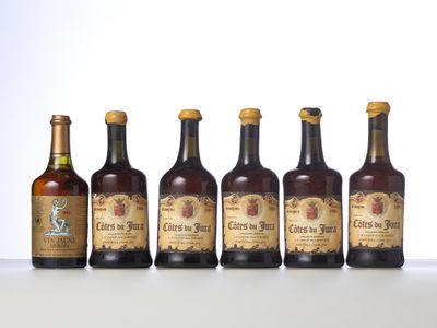 six bottles of beer lined up in a row on a table