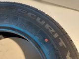 a close up of a tire with a red dot on the side of it